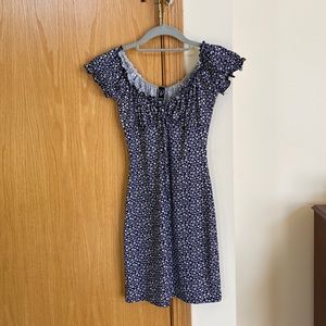 Navy blue bodycon dress with white flowers. Short, fits mid-thigh.